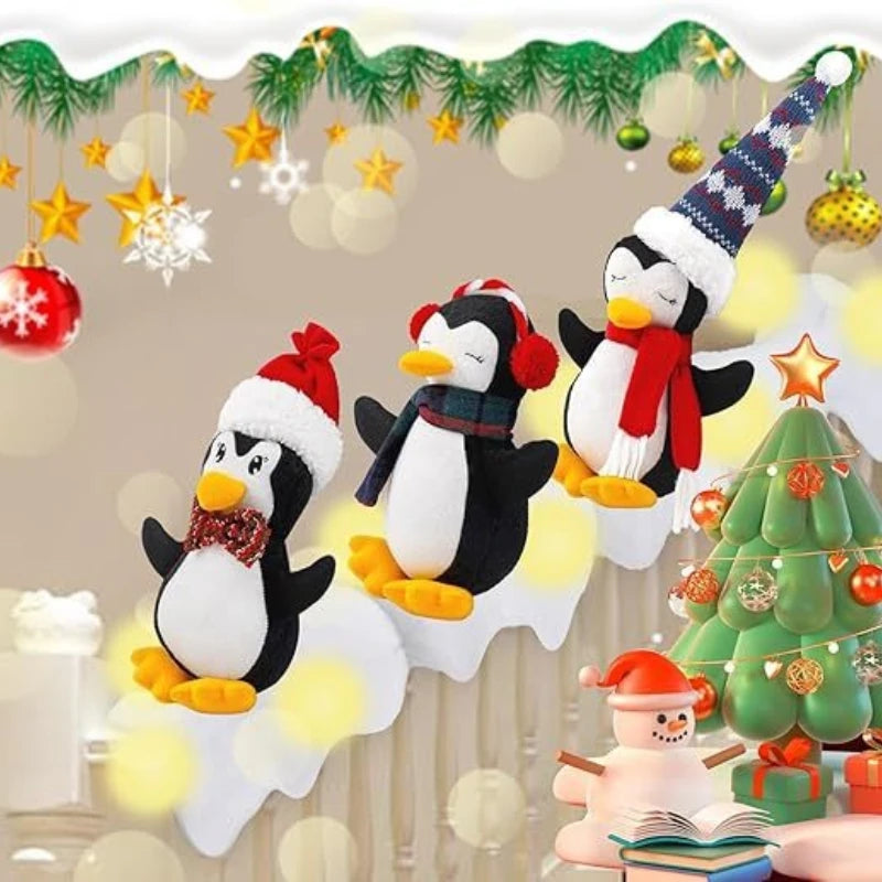 Three plush penguins in Christmas hats sliding down a snowy lit-up staircase banister
